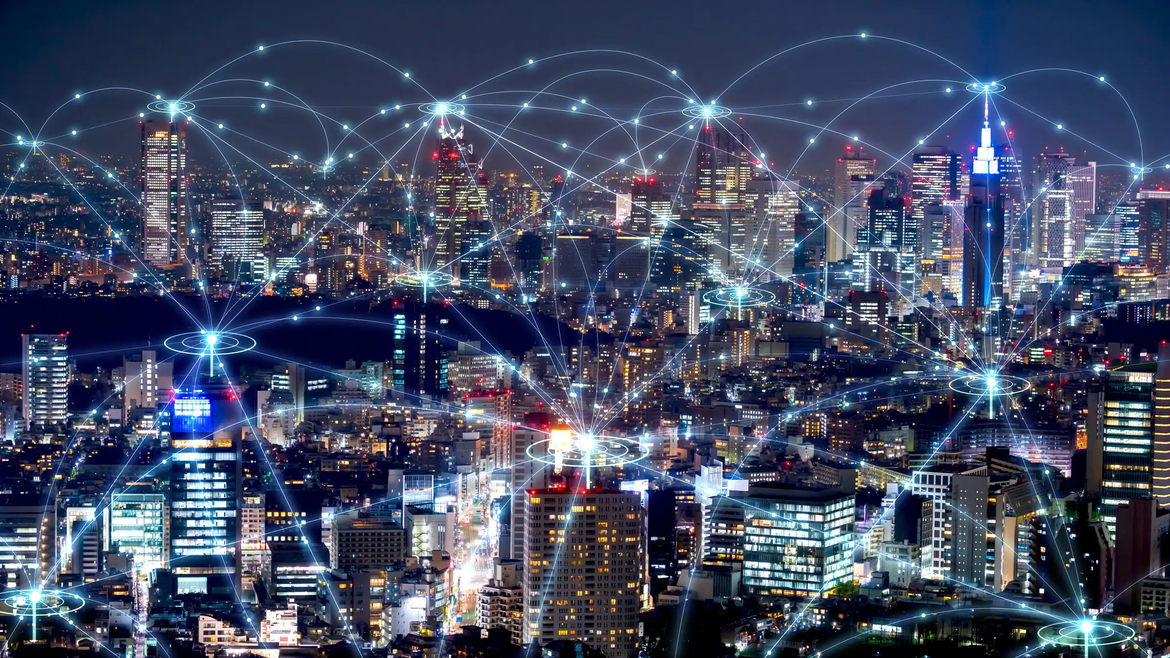 Stadtbild mit verbundenen Netzwerklinien und leuchtenden Punkten.
